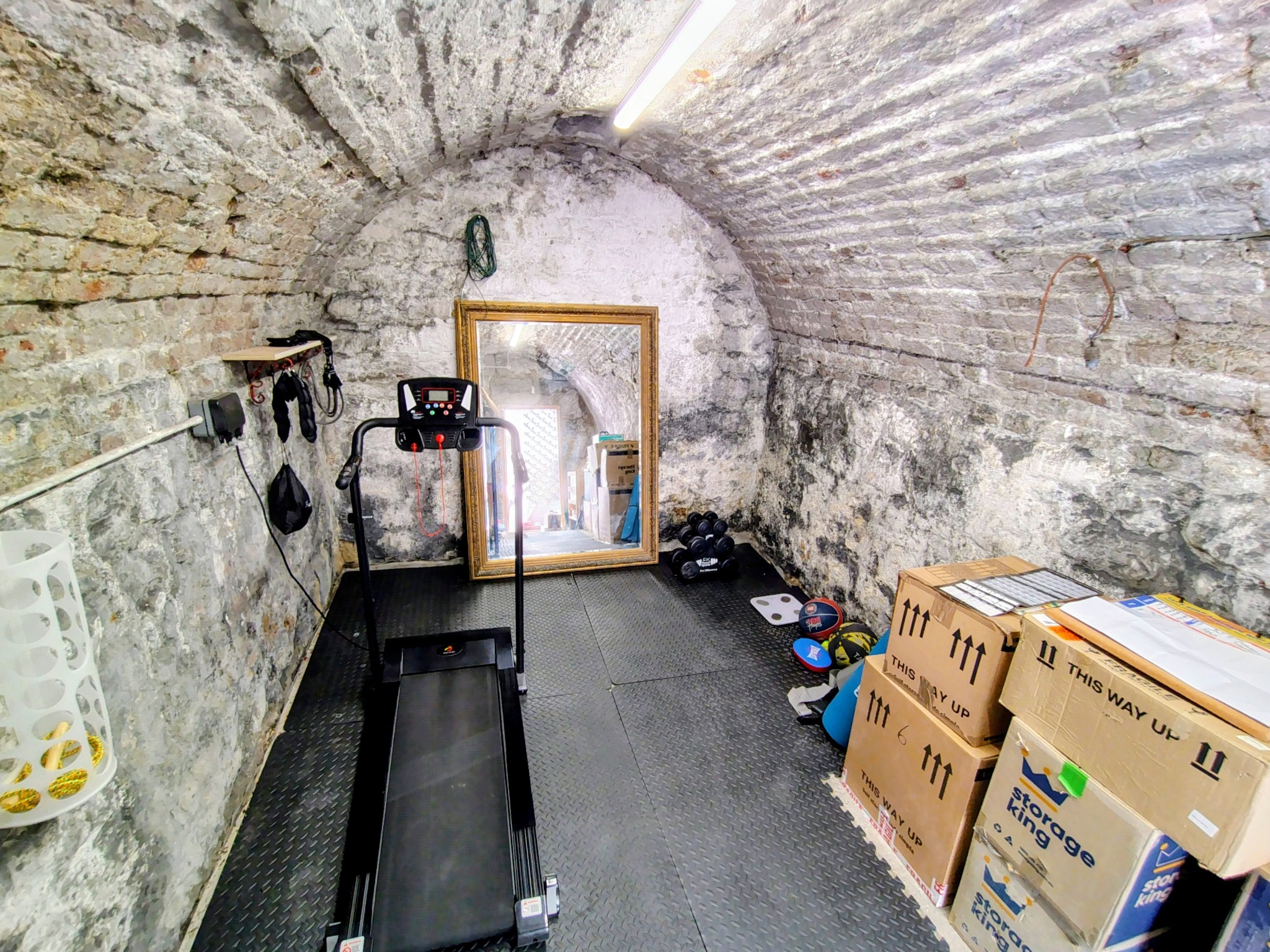 Original vaulted stone room used as a home gym